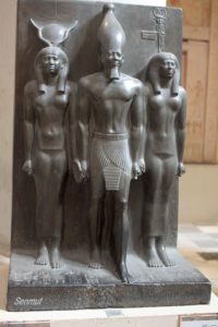 Menkaure, flanked by the goddess Hathor and Bat